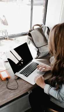 Working on a laptop at a cafe window desk